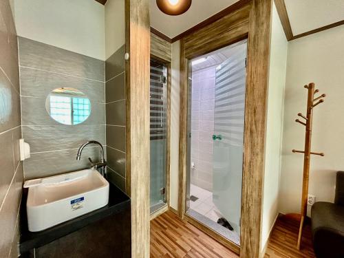 a bathroom with a sink and a shower at Okpo business hotel in Geoje