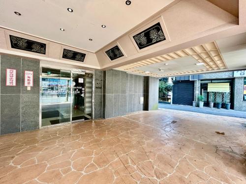 an empty lobby with a large dance floor at Okpo business hotel in Geoje 
