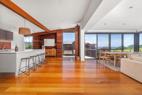 a kitchen and living room with a table and chairs at Jane's at Werri, Gerringong in Gerringong