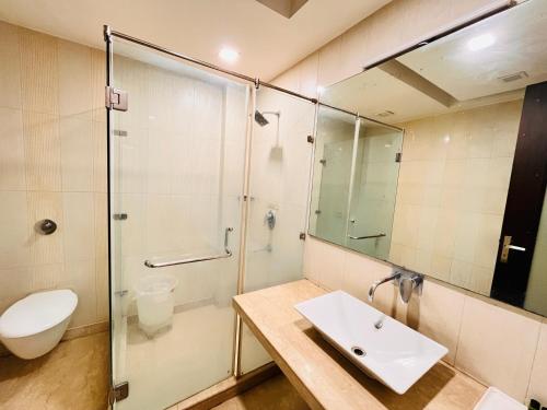 y baño con aseo, lavabo y ducha. en Hotel Lavish Inn Rajouri Garden Couple Friendly, New Delhi en Nueva Delhi