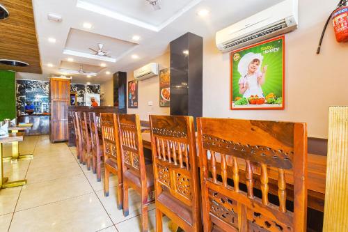 a row of wooden chairs in a restaurant at FabHotel Prime The Royal Galaxy in Udaipur