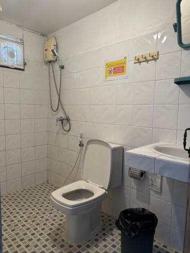 a bathroom with a toilet and a sink at THADAN GUEST HOUSE in Ban Houayxay