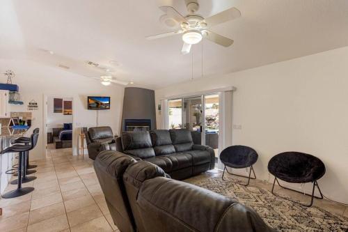 a living room with a couch and a ceiling fan at HavaMemorable Stay Pool Spa Firepit VIEWS! in Lake Havasu City