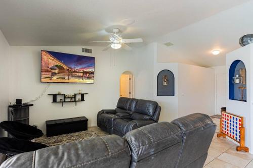 a living room with a couch and a ceiling fan at HavaMemorable Stay Pool Spa Firepit VIEWS! in Lake Havasu City