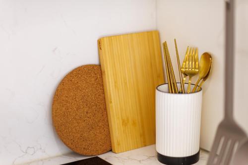 a counter with a book and a cup with forks and spoons at Wecostay Gangnam in Seoul