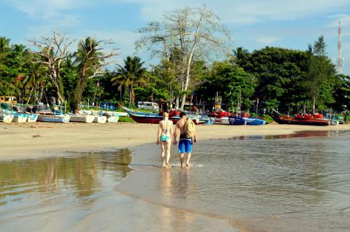 duas pessoas de pé na água na praia em Green View Weligama em Weligama