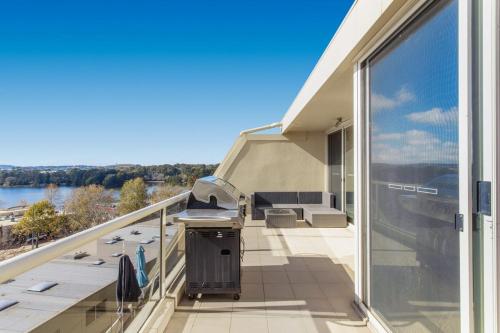 a balcony with a grill on the side of a house at 9 Chandler Street in Belconnen