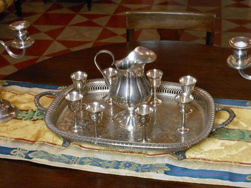 a tray with a tea kettle and cups on a table at Palazzo Antica Via Appia in Bitonto