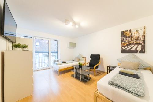 a bedroom with a bed and a living room at NEW Luxury Apartment in Heilbronn, Ludwigsburg, Backnang, Stuttgart in Beilstein