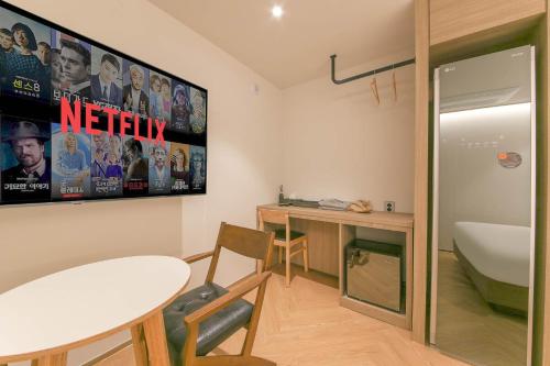 a bathroom with a sink and a table and a desk at Hound Hotel Jeonju Deokjin in Jeonju