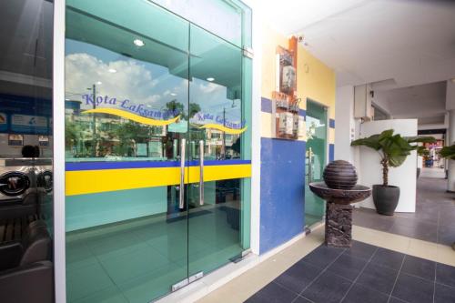 a store front with glass windows and a plant at Sun Inns Hotel Kota Laksamana Melaka in Malacca