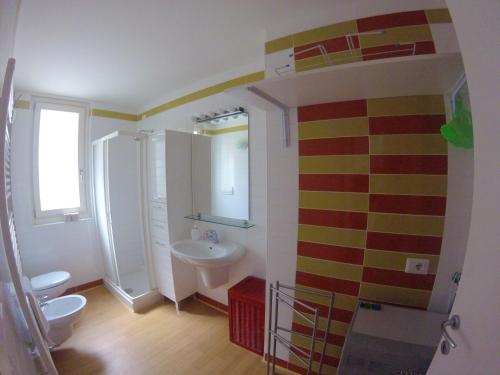 a bathroom with a white toilet and a sink at Studio Apartment Open Space with Terrace in Argegno