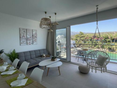 a living room with a couch and a table at Harbour lights by Smaris Collection in Sissi