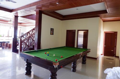 a pool table with balls on it in a room at Kongmany Prestige Hotel in Muang Không