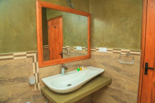 y baño con lavabo y espejo. en Mount End Hotel Nuwara Eliya, en Nuwara Eliya