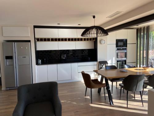a kitchen and dining room with a table and chairs at Sublime logement avec vue mer et Jacuzzi in La Ciotat