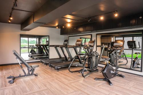a gym with treadmills and elliptical machines at Aston Serang Hotel & Convention Center in Serang