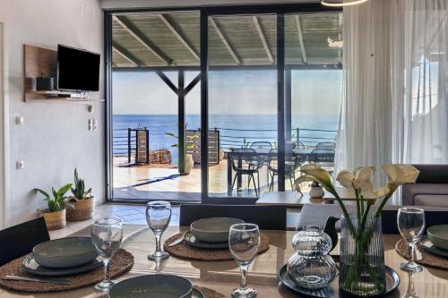 a dining room table with a view of the ocean at Horizon Studios - Apartments in Rodakino