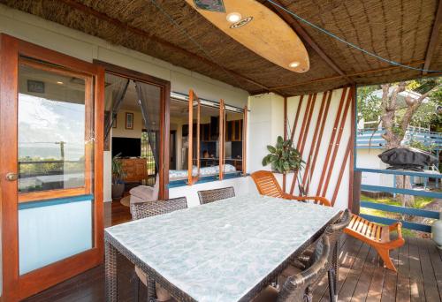 a porch with a table and chairs on a patio at Captain's Cove at Cylinder Beach in Point Lookout
