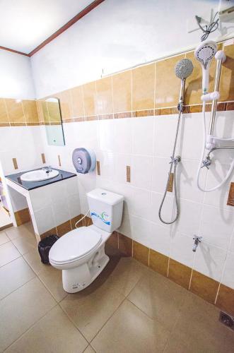 a bathroom with a toilet and a sink at Meena Resort in Chanthaburi