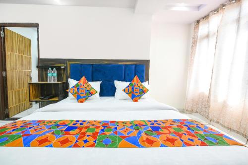 ein Schlafzimmer mit einem Bett mit einer bunten Decke in der Unterkunft FabHotel Beer Castle in Shimla