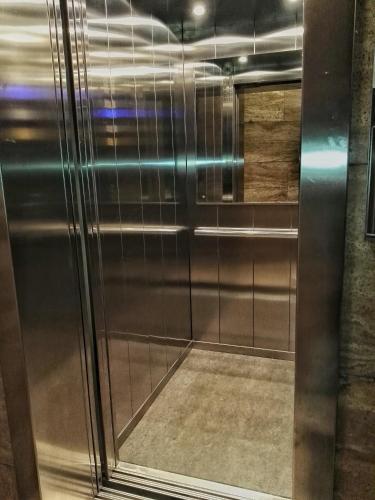 a walk in shower with a stainless steel door at Central City Rooms m09 Apartment in Bologna