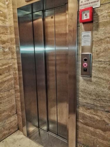 a metal elevator in a building with a sign on it at Central City Rooms m09 Apartment in Bologna