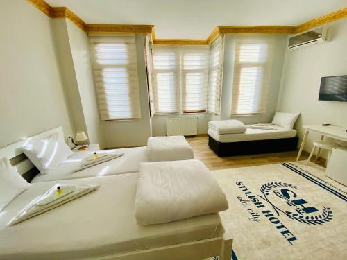 a large white bed in a room with windows at Stylish Hotel Old City in Istanbul
