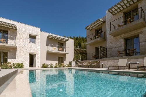 a swimming pool in front of a building at Sofibel sivota suites in Sivota