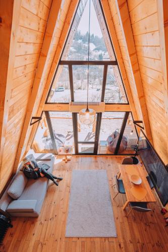 an overhead view of a living room with a large window at A Frame Cabin - Valea Vinului in Vişeu de Mijloc