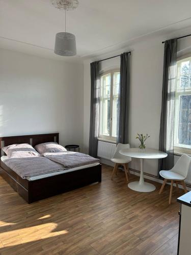 a bedroom with a bed and a table and chairs at Villa Rathenow in Rathenow