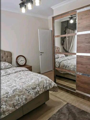 a bedroom with a bed and a mirror and a clock at شقة سياحية مطلة على البحر in Istanbul