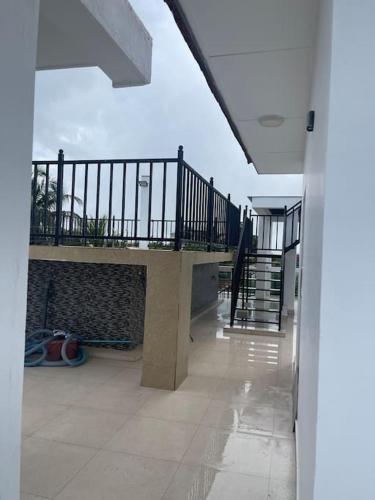 a hallway of a house with a balcony and a staircase at Maeva Luxury villa with pool in Jaffna