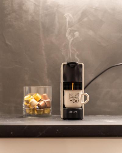 a coffee mug sitting on a shelf with a candle at Nueve / There's no place like home in Patra
