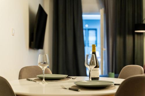 a table with a bottle of wine and two glasses at Nueve / There's no place like home in Patra