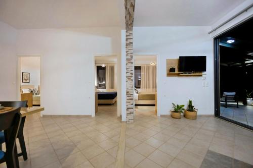 a living room with a table and a tv at Horizon Studios - Apartments in Rodakino