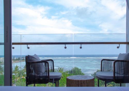 a view of the ocean from a table and chairs at Stone Beach Club in Dhiffushi