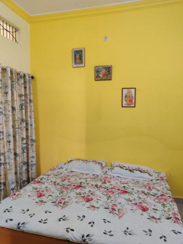 a bedroom with a bed with flowers on it at Madhuban Homestay 1 Ujjain in Ujjain
