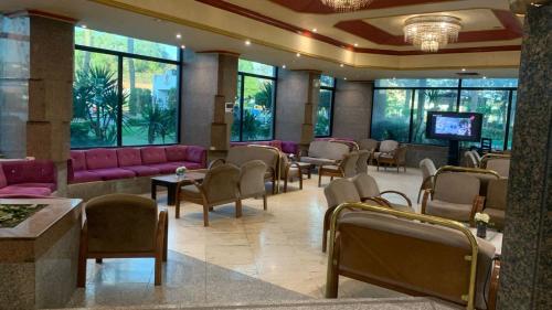 a lobby with a waiting room with pink furniture at Al-Galaa Club in Cairo