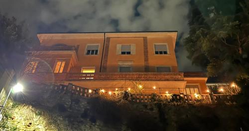 a building with lights in front of it at night at Villa Manzati in Verona