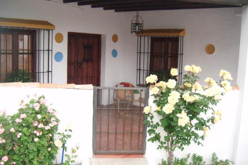 een huis met een poort en bloemen ervoor bij Casa Villazo II in Almáchar