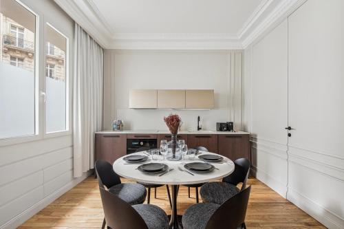 a dining room with a table and chairs at Interior Design - Apartment 6P-1BR - Tour Eiffel in Paris
