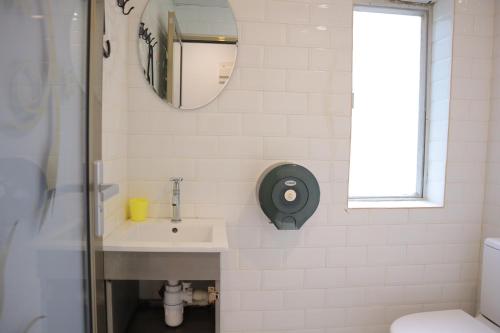 a bathroom with a sink and a mirror at Timehouse Hong Kong Hostel Group in Hong Kong