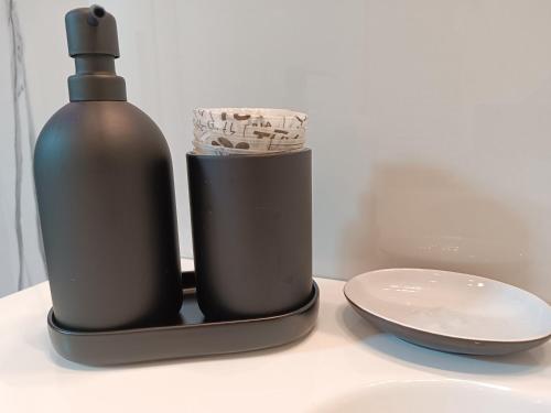 a bottle of soap and a plate on a counter at Blumoon boutique in Andria
