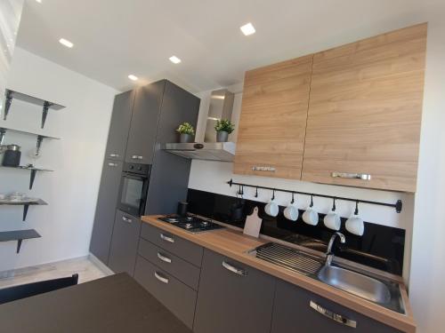 a kitchen with wooden cabinets and a sink at Blumoon boutique in Andria