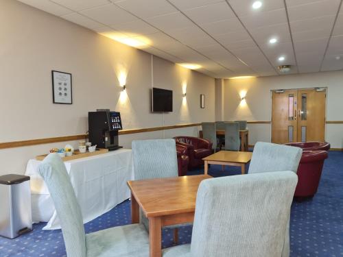 a waiting room with a table and chairs at Superior Hotel in Dudley