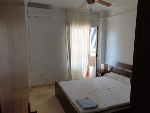 a bedroom with a large bed and a window at Miramar in Mazagón