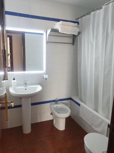 a bathroom with a sink and a toilet at Miramar in Mazagón