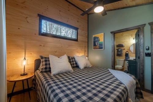 a bedroom with a bed in a room with a window at Hot Tub, Games, Fireplace & Fast WiFi Near Dollywood in Sevierville