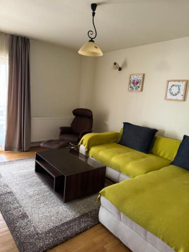 a living room with a couch and a coffee table at Cetatuia in Măgura